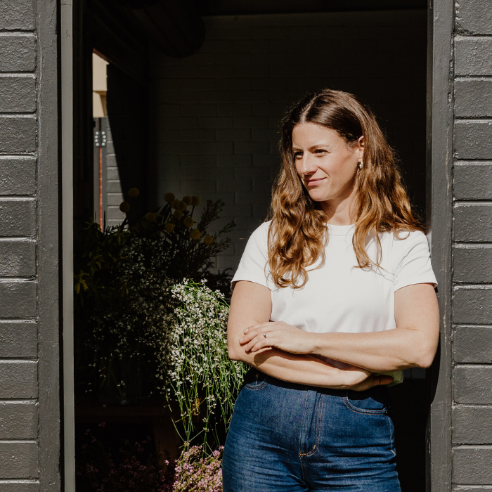Your Local Perth Florist standing with crossed arms in door way of florist studio perth